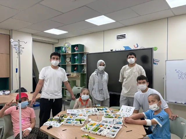 The RoboCare team building a Lego robot with children on a ward